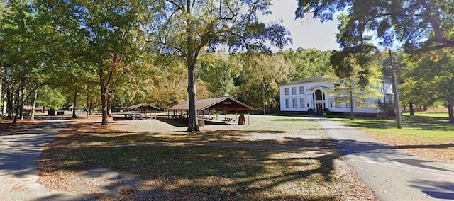 view of community with driveway, a gazebo, and a carport