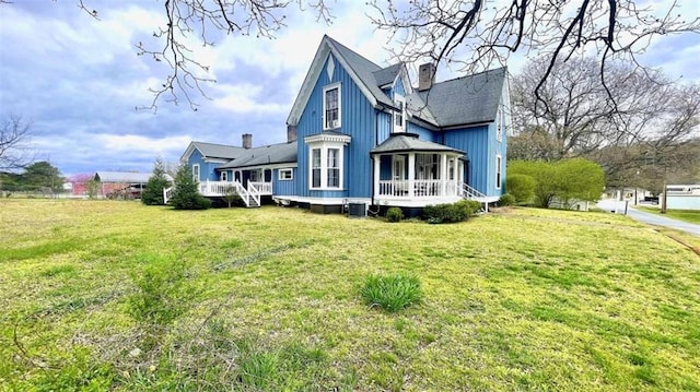 view of property exterior featuring a lawn, a wooden deck, a chimney, central AC unit, and a shingled roof