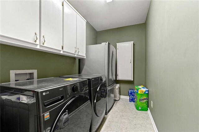 laundry area with washer and clothes dryer, cabinet space, and baseboards