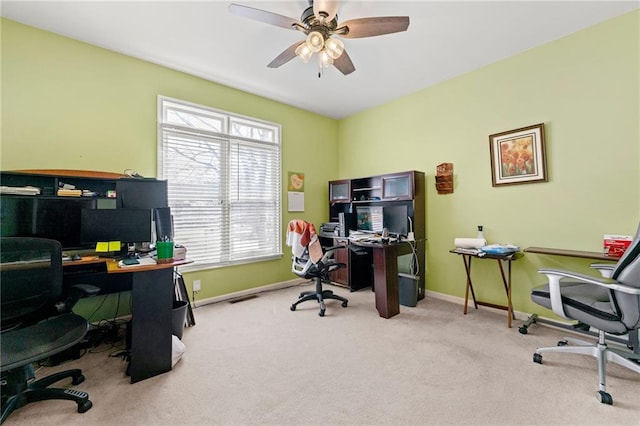 carpeted office featuring a ceiling fan, visible vents, and baseboards