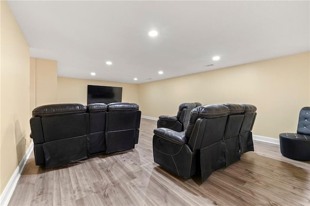 home theater featuring light wood finished floors, recessed lighting, and baseboards