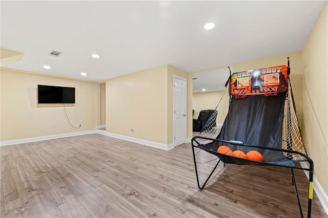 rec room with recessed lighting, wood finished floors, visible vents, and baseboards