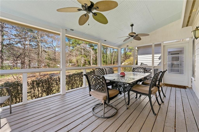 sunroom with vaulted ceiling and a ceiling fan