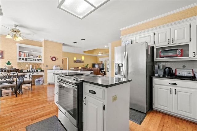 kitchen featuring white cabinets, dark countertops, a kitchen island, stainless steel appliances, and light wood-type flooring