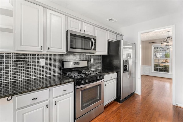 kitchen featuring visible vents, white cabinets, appliances with stainless steel finishes, and dark wood-style flooring