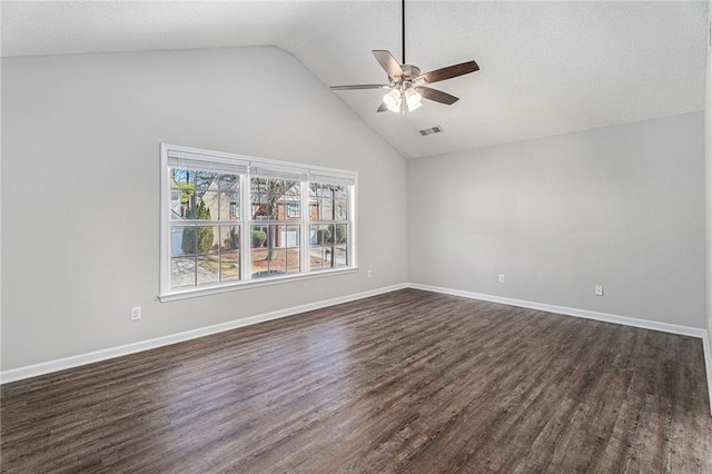 empty room with dark wood finished floors, vaulted ceiling, baseboards, and ceiling fan