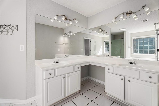 bathroom with double vanity, visible vents, and a sink