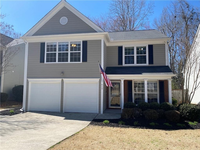 traditional-style home featuring brick siding, concrete driveway, and an attached garage