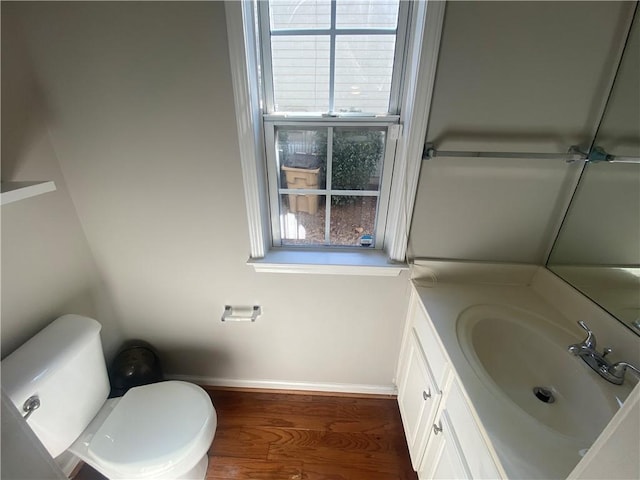 bathroom with vanity, toilet, plenty of natural light, and wood finished floors