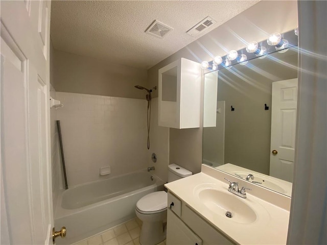 bathroom featuring visible vents, toilet, vanity, and a textured ceiling