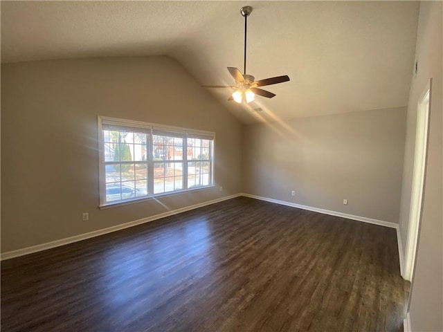 unfurnished room featuring ceiling fan, baseboards, dark wood finished floors, lofted ceiling, and a textured ceiling