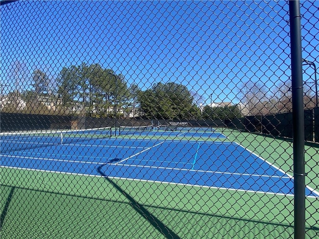 view of sport court featuring fence