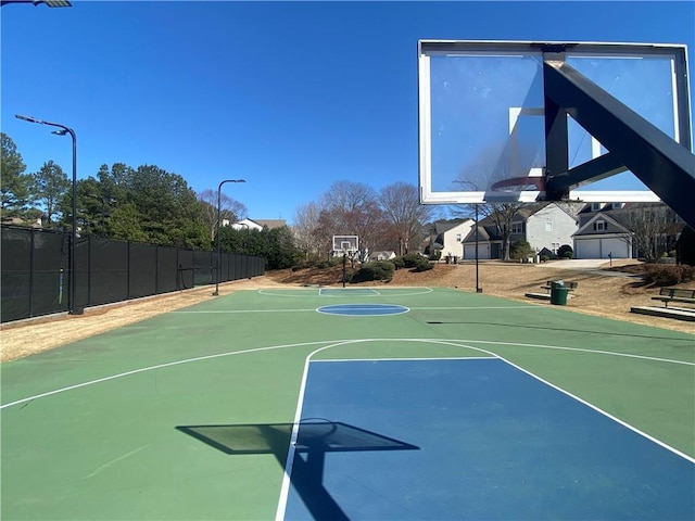 view of basketball court featuring community basketball court and fence