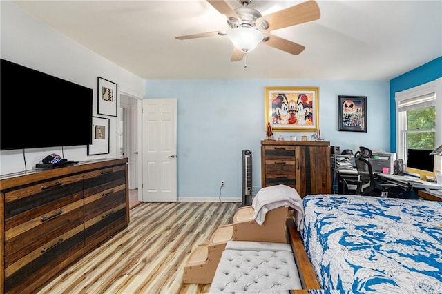 bedroom with light hardwood / wood-style flooring and ceiling fan