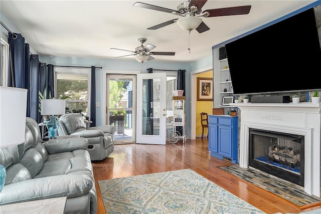 living room featuring ceiling fan and dark wood-type flooring