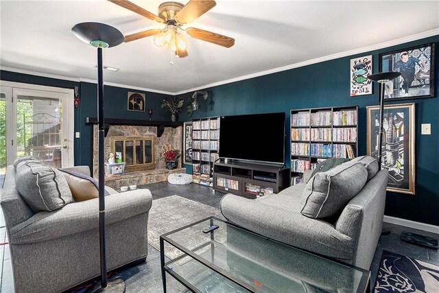 living room with a stone fireplace, ornamental molding, tile patterned flooring, and ceiling fan