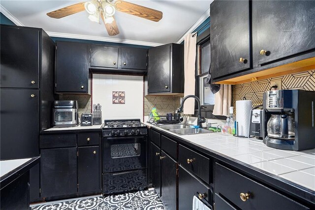 kitchen with tasteful backsplash, light tile patterned floors, ceiling fan, sink, and gas stove