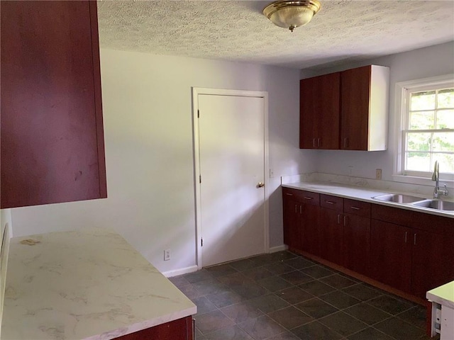 kitchen with a textured ceiling and sink