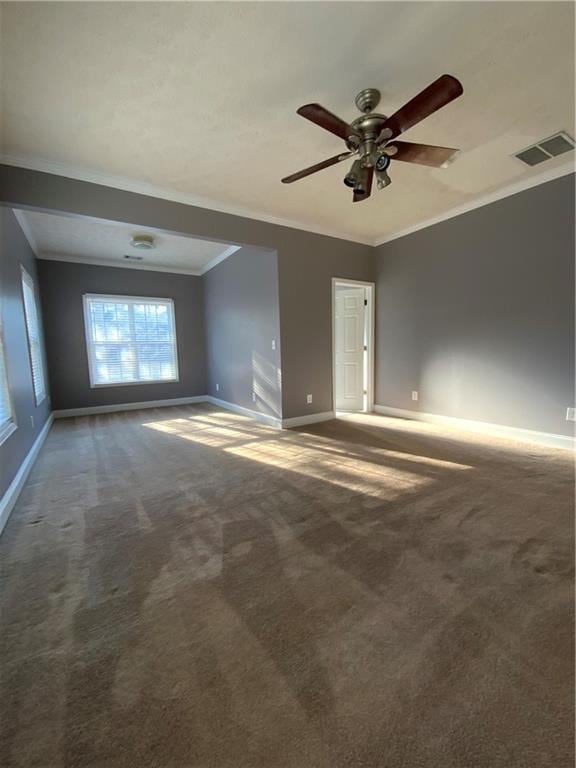 carpeted spare room featuring ceiling fan and ornamental molding