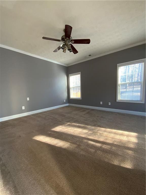 carpeted spare room featuring ceiling fan and ornamental molding