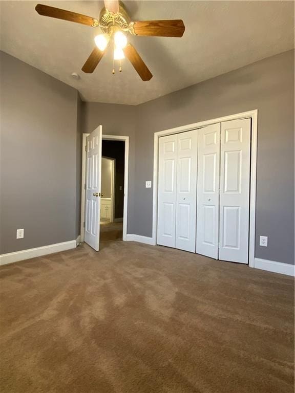 unfurnished bedroom with ceiling fan, carpet, and a closet