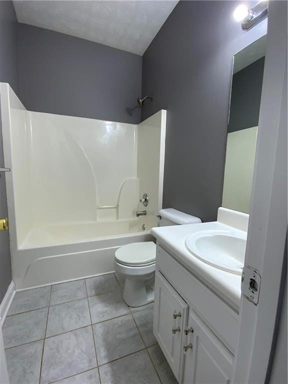 full bathroom featuring toilet, vanity, tile patterned floors, and shower / bathing tub combination