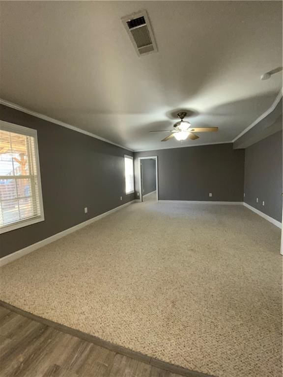 spare room featuring ceiling fan, hardwood / wood-style floors, and crown molding