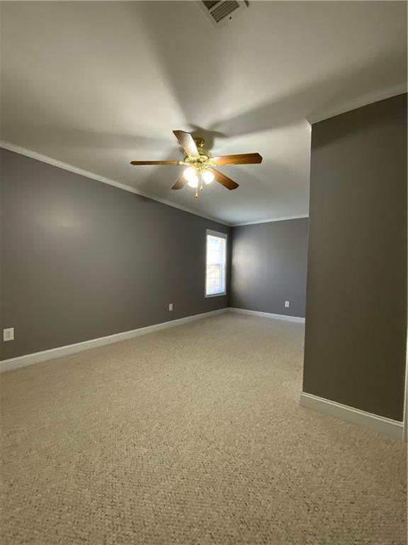 spare room featuring crown molding and ceiling fan