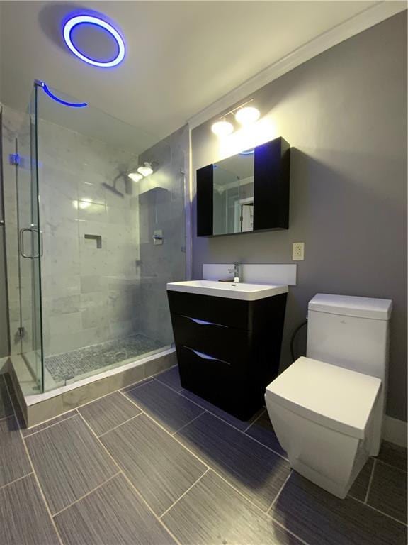 bathroom featuring ornamental molding, toilet, walk in shower, and vanity