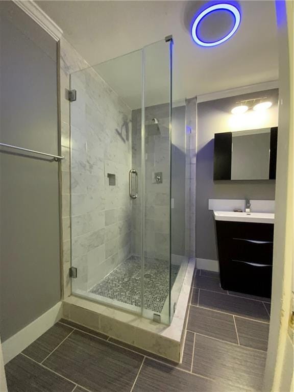 bathroom featuring a shower with door, tile patterned flooring, and vanity