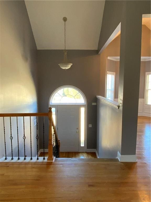 entrance foyer with a wealth of natural light, light hardwood / wood-style flooring, and lofted ceiling