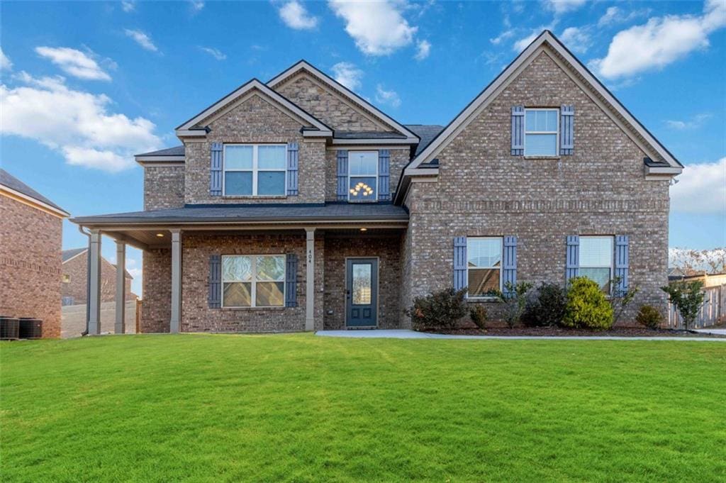 view of front of house featuring central AC unit and a front lawn