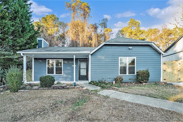 single story home with covered porch and a chimney