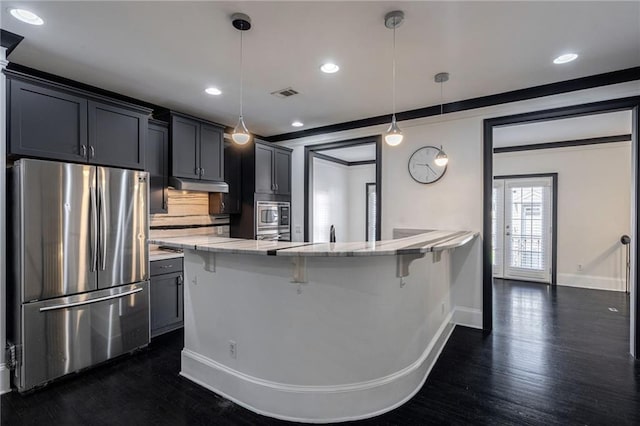 2767 Durham Dr NE, Atlanta, GA 30319 - kitchen with stainless steel appliances, under cabinet range hood, baseboards, a breakfast bar area, and recessed lighting