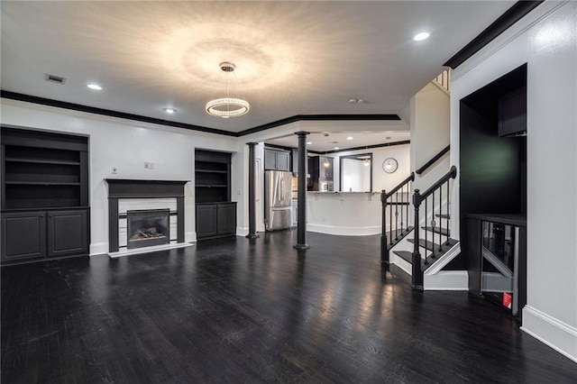 2767 Durham Dr NE, Atlanta, GA 30319 - unfurnished living room featuring decorative columns, wood finished floors, baseboards, stairs, and ornamental molding