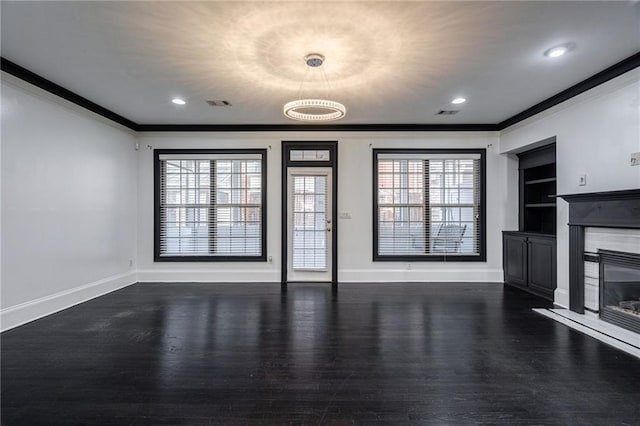 2767 Durham Dr NE, Atlanta, GA 30319 - unfurnished living room with crown molding, wood finished floors, a high end fireplace, baseboards, and built in shelves