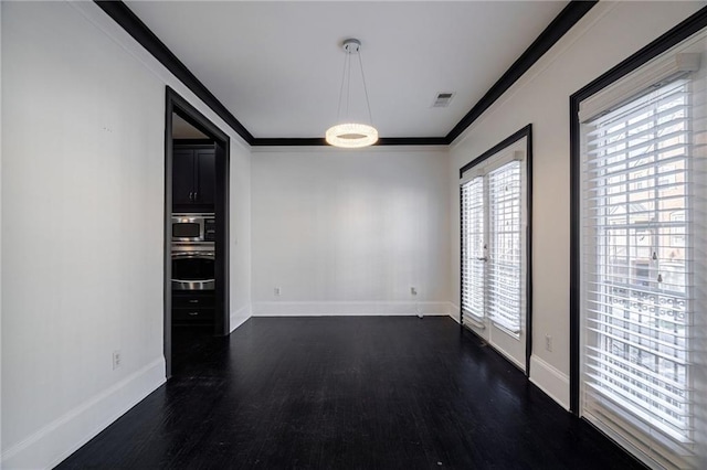 2767 Durham Dr NE, Atlanta, GA 30319 - unfurnished dining area with dark wood finished floors, baseboards, and crown molding