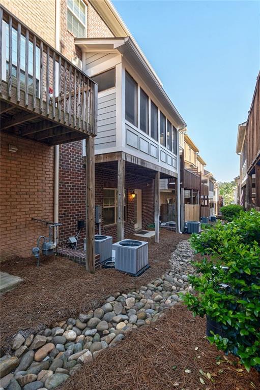 2767 Durham Dr NE, Atlanta, GA 30319 - rear view of property featuring cooling unit and brick siding