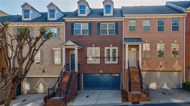 2767 Durham Dr NE, Atlanta, GA 30319 - townhome / multi-family property with a garage, brick siding, driveway, and stairway