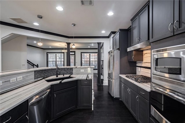 2767 Durham Dr NE, Atlanta, GA 30319 - kitchen with appliances with stainless steel finishes, a sink, ornate columns, backsplash, and recessed lighting