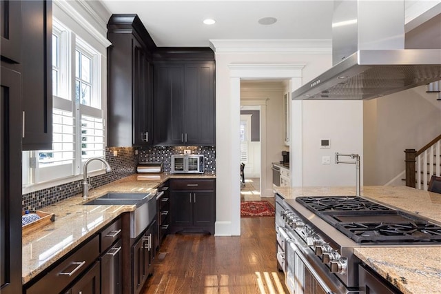 kitchen with crown molding, island range hood, light stone countertops, and dark wood-type flooring