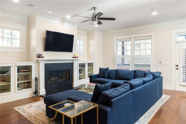 living room with ornamental molding and plenty of natural light