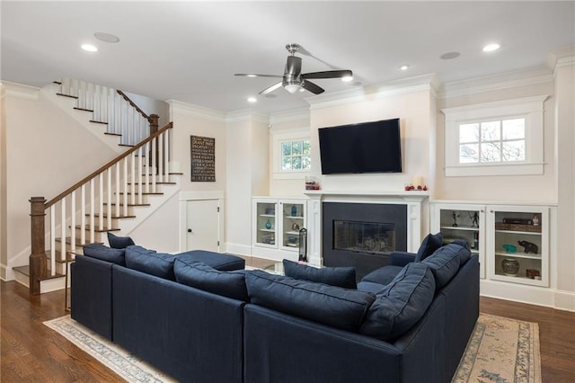 living room with crown molding, ceiling fan, and dark hardwood / wood-style flooring