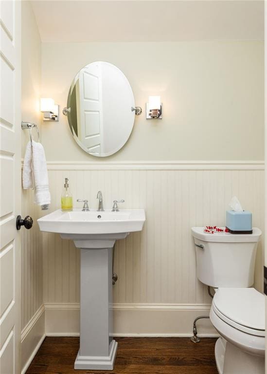 bathroom with wood-type flooring and toilet