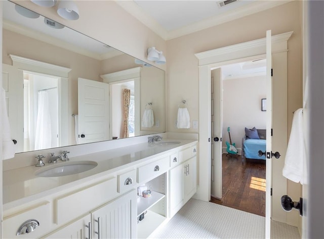 bathroom with vanity, hardwood / wood-style flooring, and ornamental molding