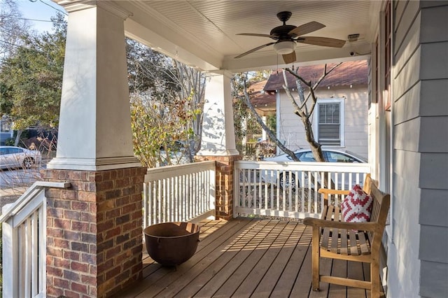 wooden terrace featuring ceiling fan and a porch