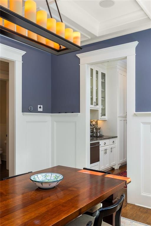 dining room featuring hardwood / wood-style floors and crown molding