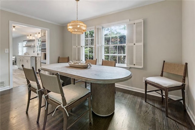 dining space featuring healthy amount of natural light, a chandelier, baseboards, dark wood-style floors, and ornamental molding