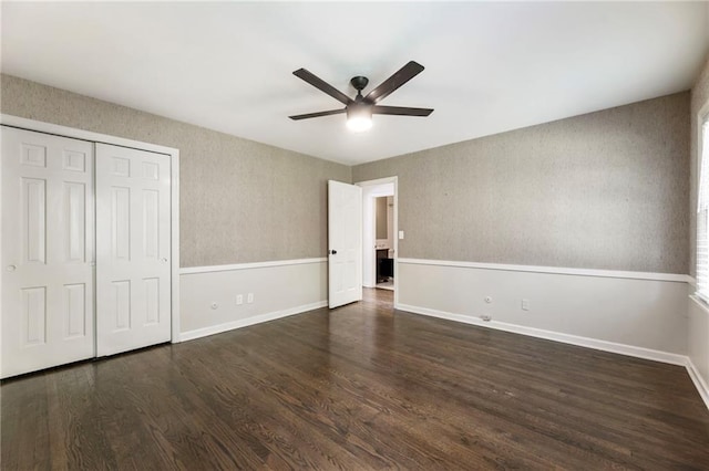unfurnished bedroom featuring wood finished floors, a closet, ceiling fan, and baseboards