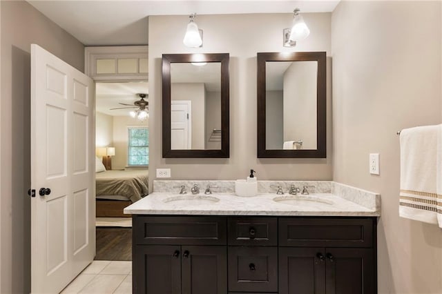 full bath with ensuite bathroom, double vanity, a ceiling fan, and tile patterned flooring